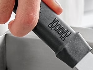 Up close showing a hand holding the 9 inch stainless steel mini grill spatula