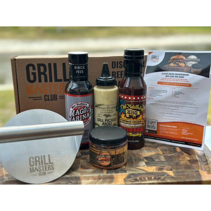 Smokin’ Smashburger BBQ Box with sauces, rubs, and burger press on wood table