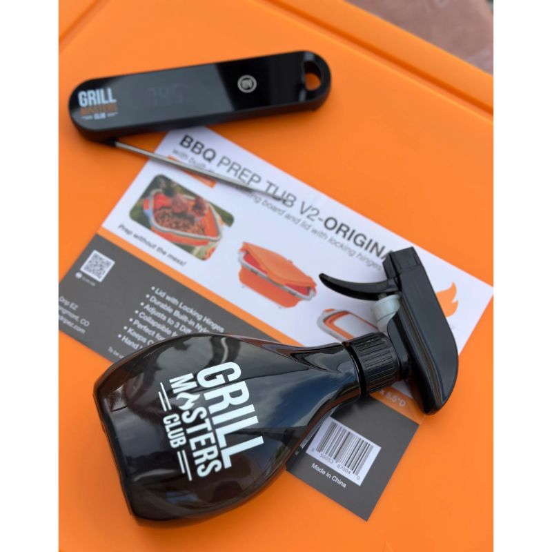 Closeup of Grill Masters Club Spray Bottle and Meat Thermometer on Drip EZ Prep Tub