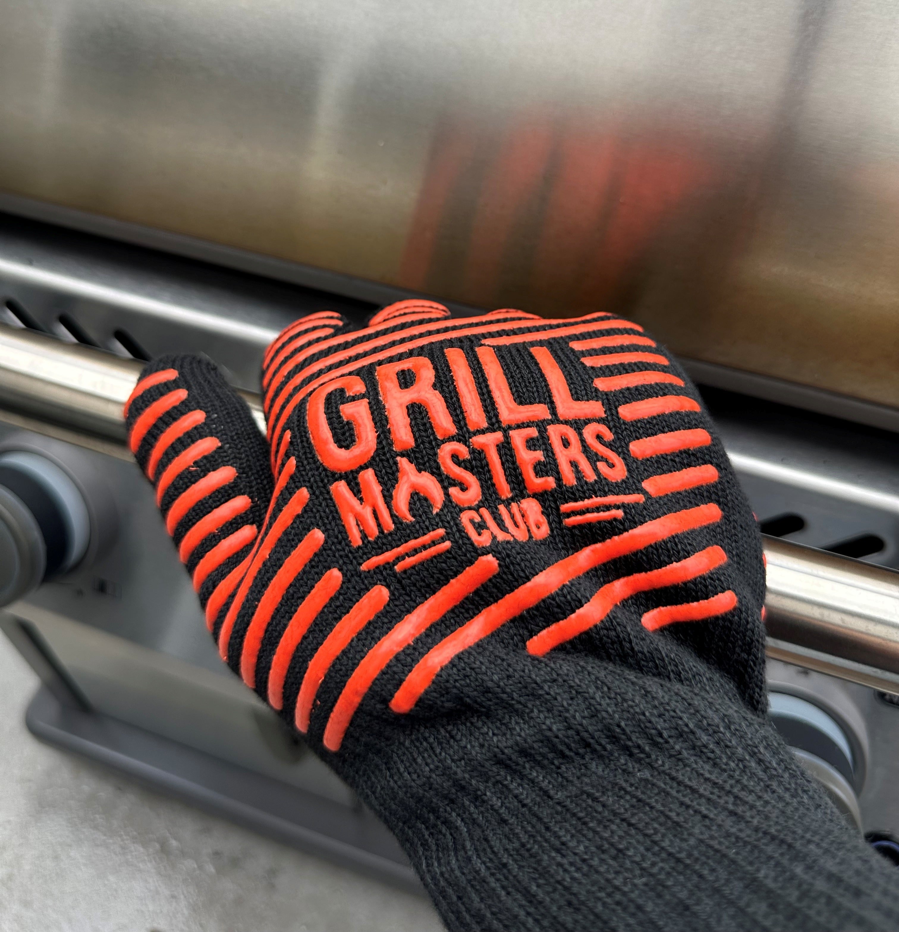 Closeup of Grill Masters Club Grilling Glove Holding the Lid of a Grill