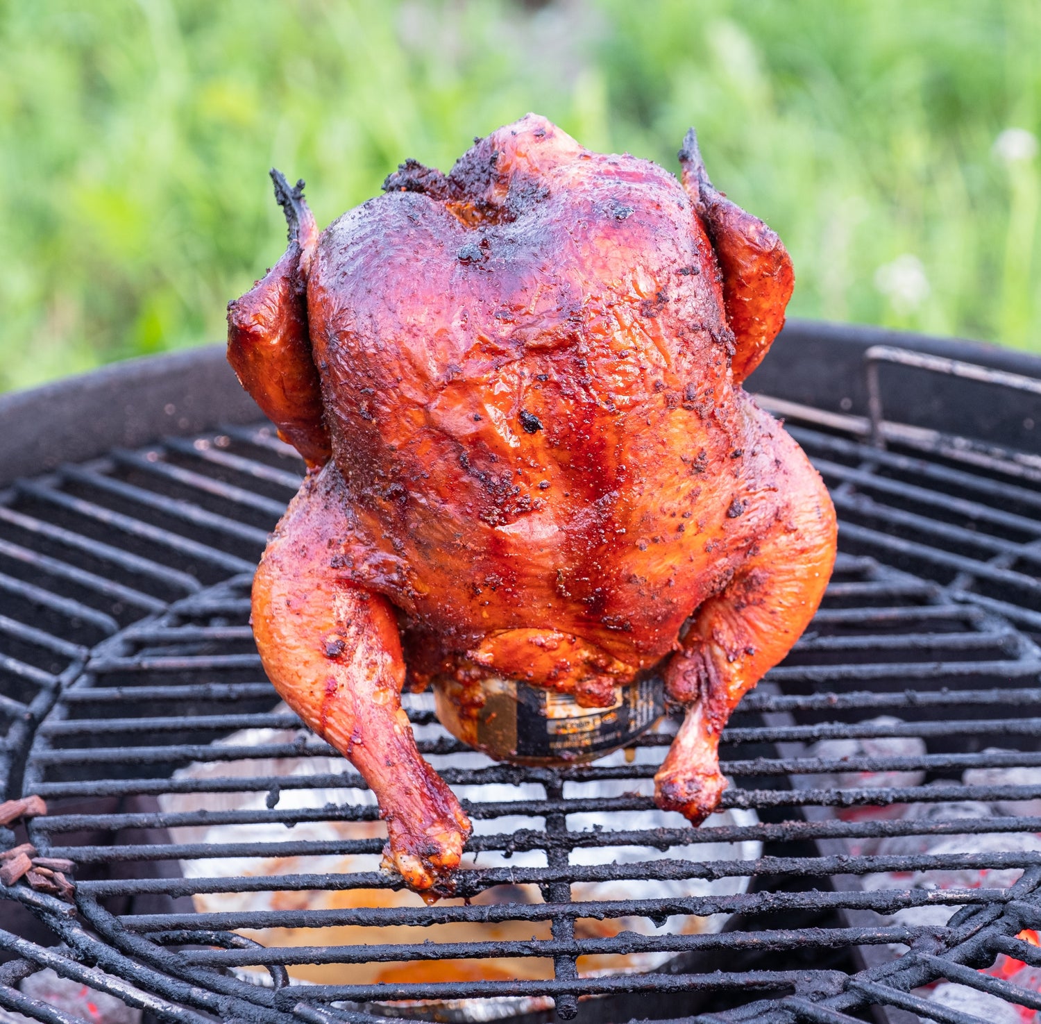 Close up of a beer can chicken on a grill